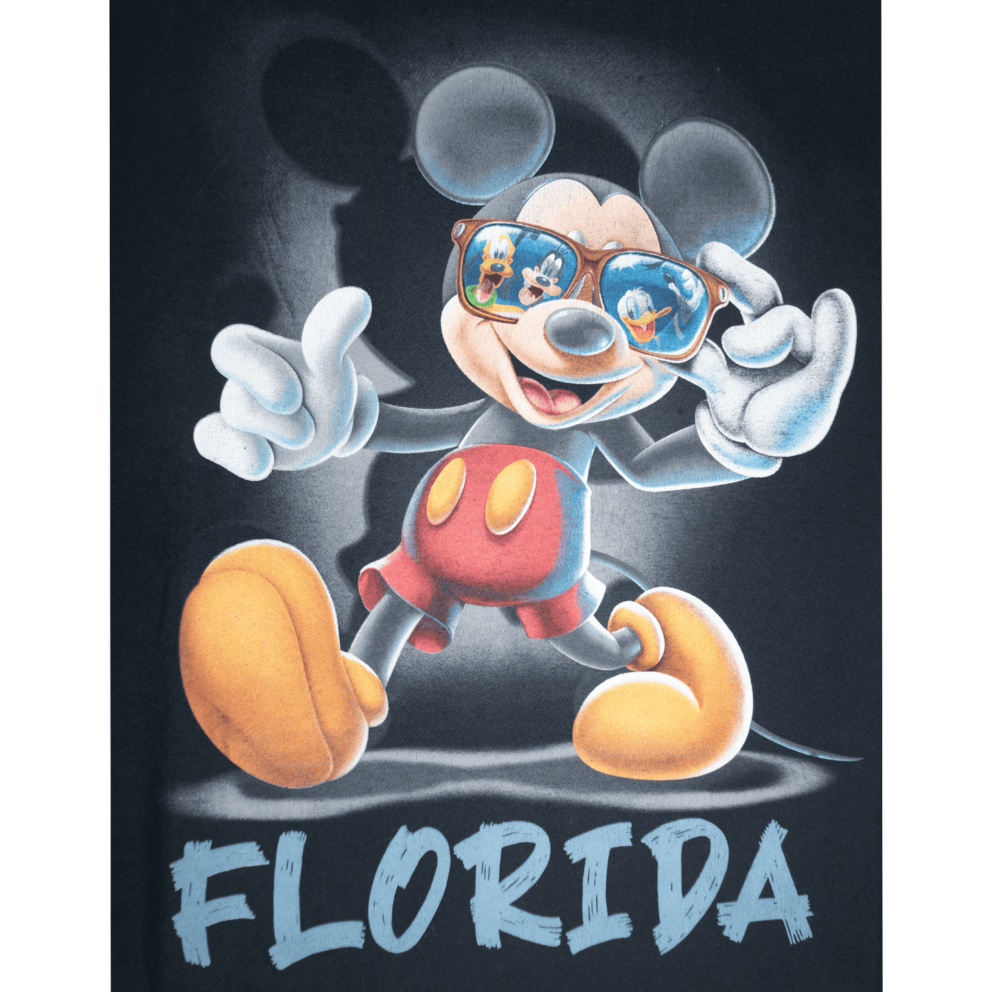 Mickey Mouse in sunglasses with reflections of friends, featuring the word 'FLORIDA' on a T-shirt.