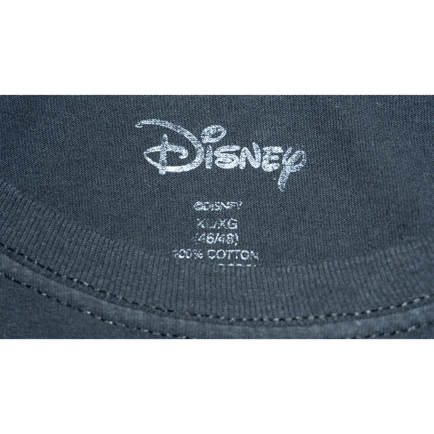 Close-up of the Disney label on a black T-shirt, showing size details and fabric composition.