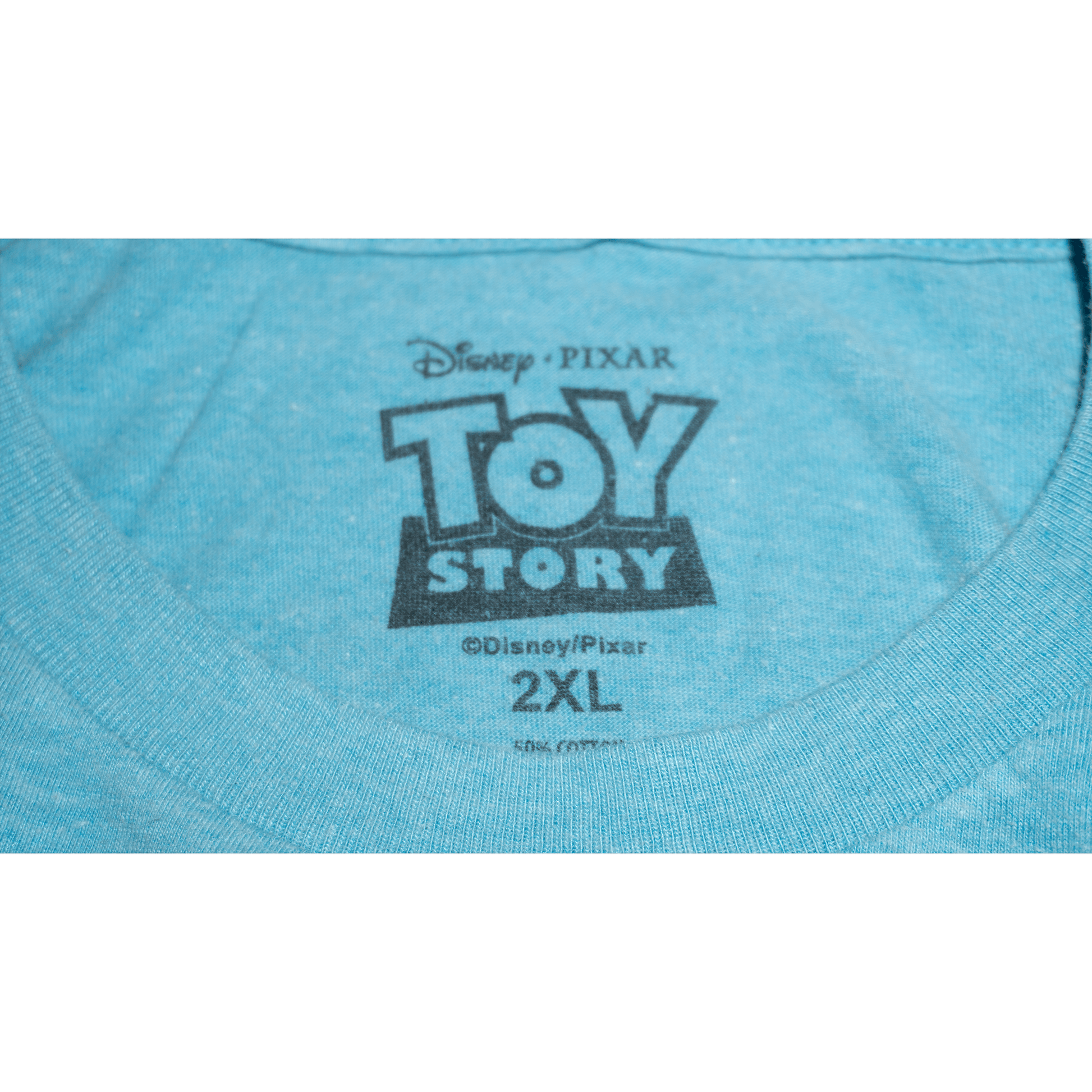 Close-up of a blue Toy Story T-shirt tag featuring Disney and Pixar logos, marked size 2XL.