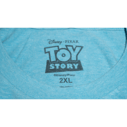 Close-up of a blue Toy Story T-shirt tag featuring Disney and Pixar logos, marked size 2XL.