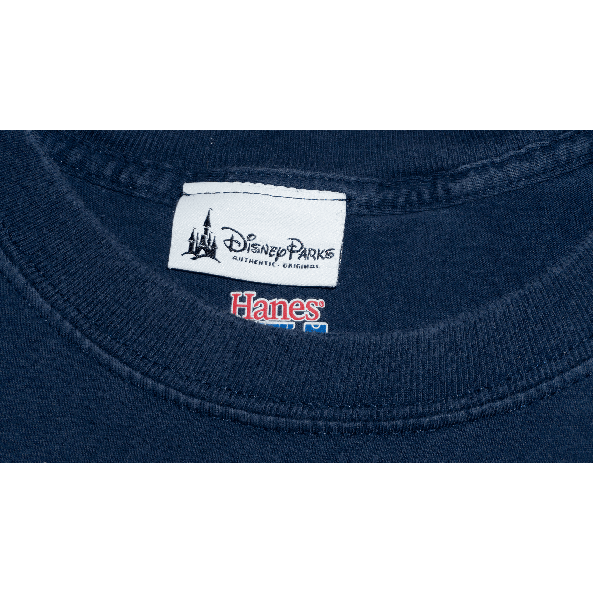 Disney Parks label and Hanes tag on a navy T-shirt collar, showcasing authenticity and brand.