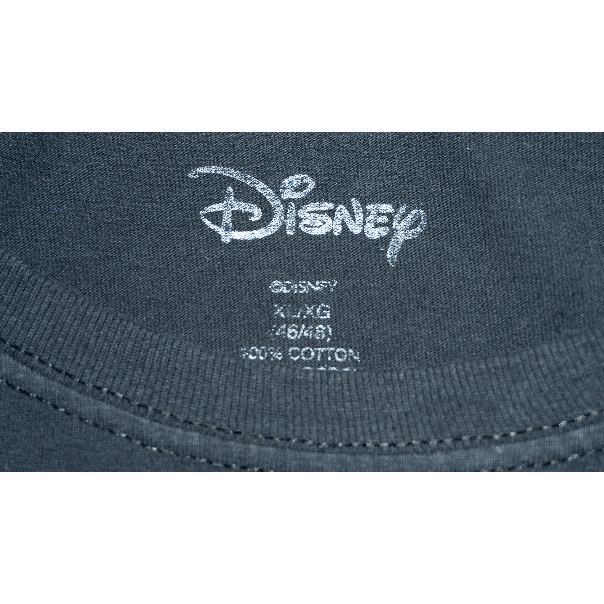 Close-up of the Disney label on a black T-shirt, showing size details and fabric composition.