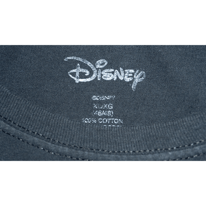 Close-up of the Disney label on a black T-shirt, showing size details and fabric composition.