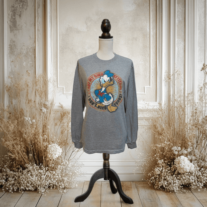 Gray long-sleeve T-shirt featuring a large print of Donald Duck with colorful graphics.